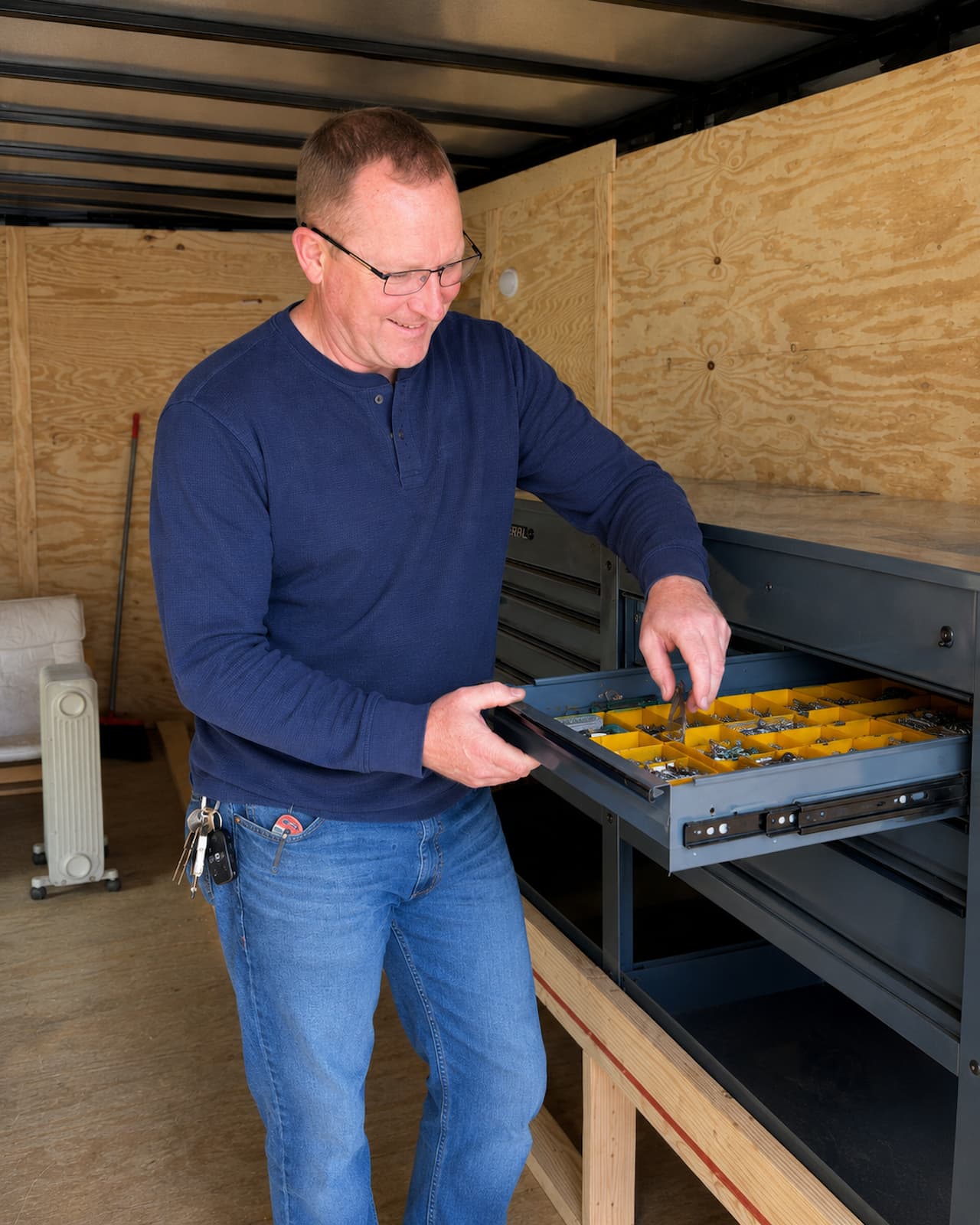 Mitch cutting materials at the mobile workshop